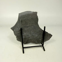 Load image into Gallery viewer, Large dark gray stone on a black stand against a white background