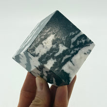 Load image into Gallery viewer, Marble-patterned cube held by a hand against a white background