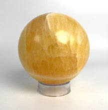 Load image into Gallery viewer, Honeycomb Calcite from Utah carved and polished into a stunning sphere with bright colors and unique pattern