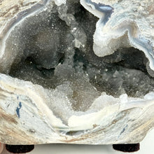 Load image into Gallery viewer, Close-up of a geode with crystal formations inside