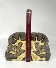 Load image into Gallery viewer, Utah Septarian Bookend with visible fossil remnants holding a book