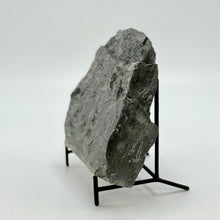 Load image into Gallery viewer, Large gray stone on a black stand against a white background