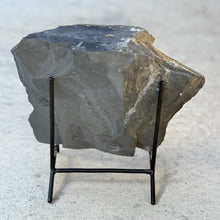 Load image into Gallery viewer, Geometric piece of shale rock on a stand against a light gray background
