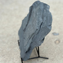 Load image into Gallery viewer, Dark gray stone on a stand against a light background