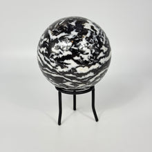 Load image into Gallery viewer, Black and white highly polished zebra marbled sphere on a stand against a white background

