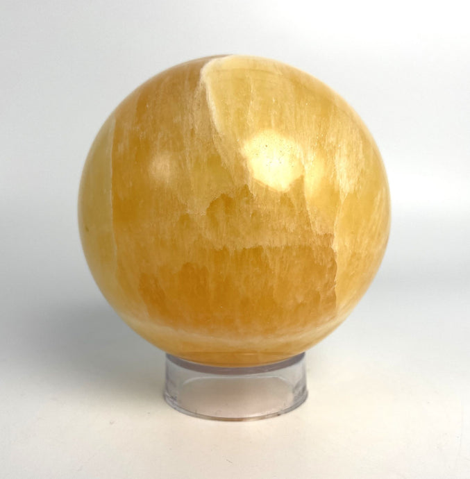 Honeycomb Calcite from Utah carved and polished into a stunning sphere with bright colors and unique pattern
