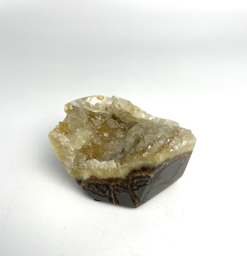 Septarian free form lapidary carved and highly polished with a stunning yellow and clear calcite crystal formation interior