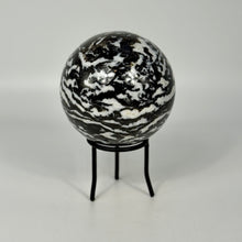 Load image into Gallery viewer, Black and white zebra marbled sphere on a stand against a gray background
