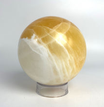 Load image into Gallery viewer, Honeycomb Calcite from Utah carved and polished into a stunning sphere with bright colors and unique pattern
