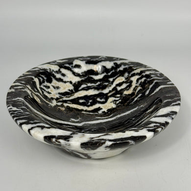 Black and white marbled lapidary shaped and polished bowl on a light gray background