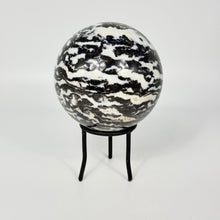 Load image into Gallery viewer, Zebra marble patterned sphere on a black metal stand against a white background
