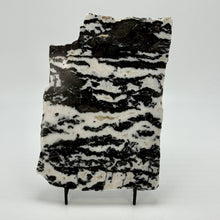 Load image into Gallery viewer, Black and white patterned Zebra marble slab stone on a stand against a white background
