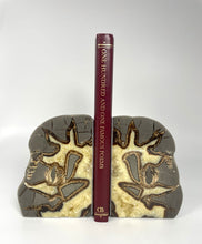 Load image into Gallery viewer, Utah Septarian Bookend with visible fossil remnants holding a book
