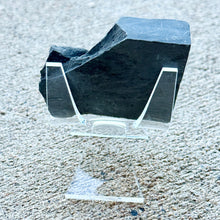 Load image into Gallery viewer, Wheeler shale on a clear stand against a textured surface
