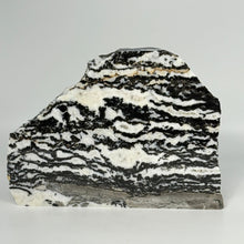 Load image into Gallery viewer, Highly polished Marble slab with black and white pattern on a gray background
