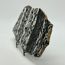 Load image into Gallery viewer, Decorative zebra marble slab with zebra pattern on a stand against a white background
